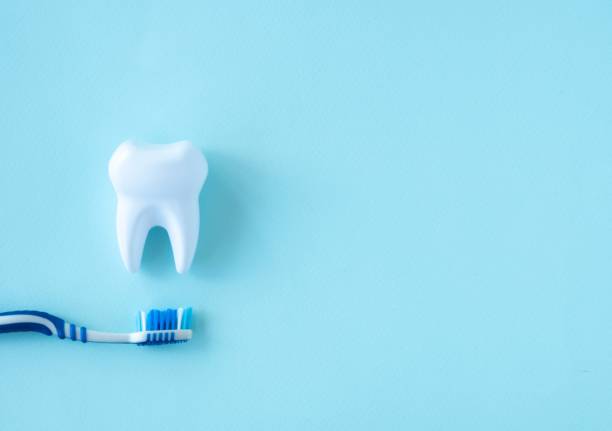 istock Dental concept tooth and brush on a blue background. 1350598731