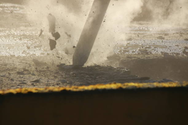 Demolition of a ceiling with a large chisel photographed in backlight