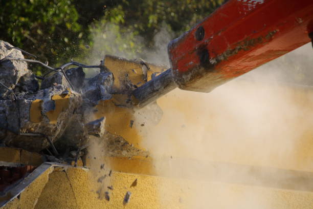 istock Demolition of a house wall with a large chisel 1350599550