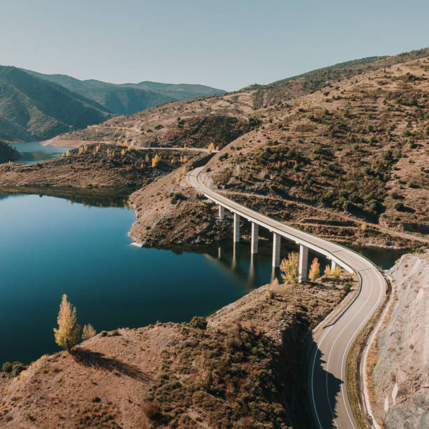 istock Road with curves by a lake 1350600985