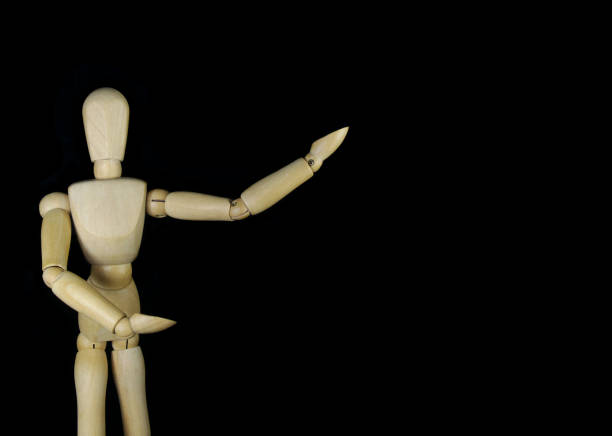 istock Wooden mannequin isolated on black background with room for text 1350602141