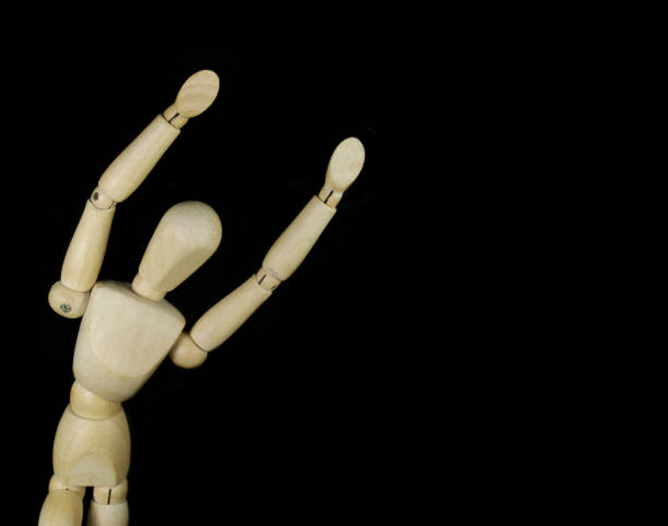istock Wooden figurine isolated on black background 1350602144