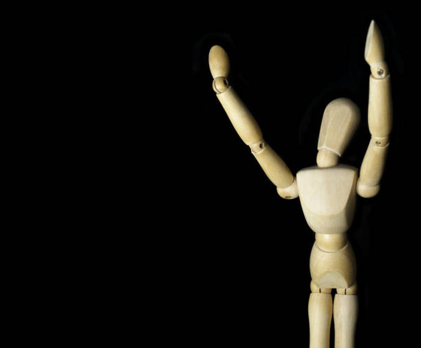 istock Wooden figurine isolated on black background 1350602151