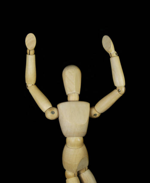 istock Wooden figurine isolated on black background 1350602171