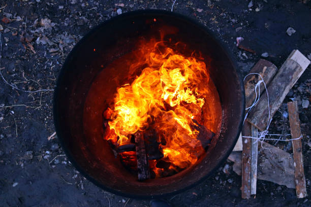 istock top view of an orange flame in an old iron barrel 1350603687