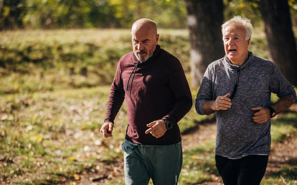 istock Senior friends jogging together 1350604084