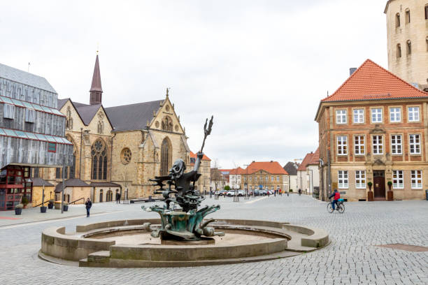Paderborn with the Neptune Fountain Paderborn, Nordrhein-Westfalen-Germany - 02-04-2021:The Neptune fountain from behind in Paderborn the cathedral and the city hall on a square with cobblestones paderborn stock pictures, royalty-free photos & images