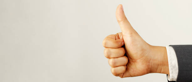 Businessman cool show hand giving thumb up as sign of Success. stock photo