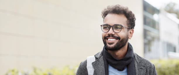 istock Handsome young man wearing warm clothing looking up, banner 1350606154