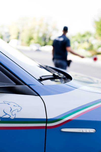 Padua, Italy - October 4, 2021. Police patrol car and officer in Padua during security activity. See Alfa Romeo Giulietta as Italian Police Patrol car.