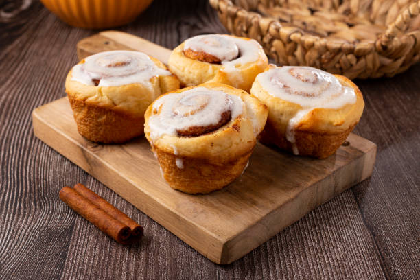 istock Cinnamon rolls on wooden background. 1350606524