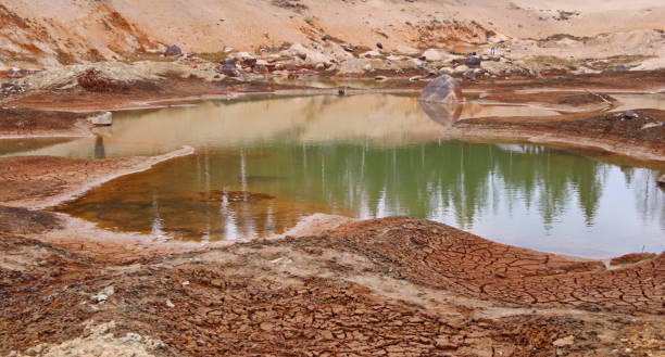 istock Dirty bottom of a dried-up lake. Ecological problems. 1350606541