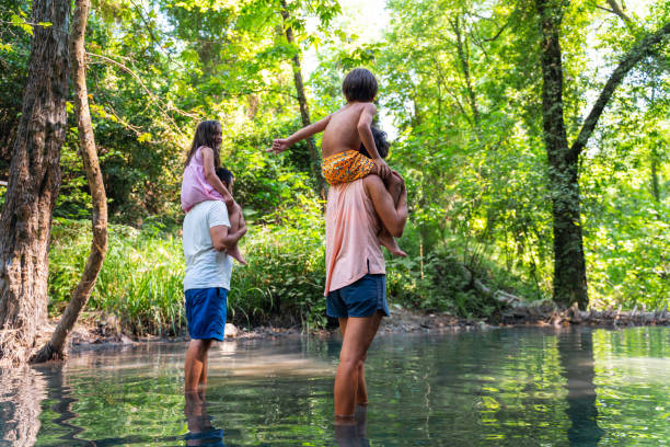 istock Young family walking on pathway in forest 1350609162