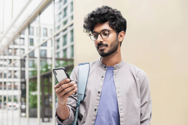 Handsome young man using smart phone in a city stock photo