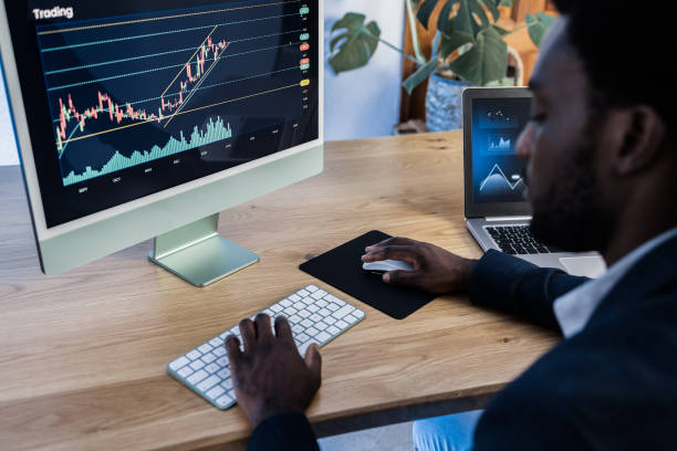istock African trader studying stock market at home - Focus on computer screen 1350609426