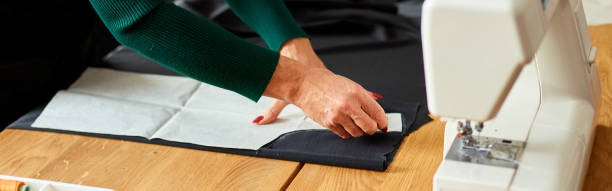 istock Banner Woman dressmaker female making sewing patterns 1350609470