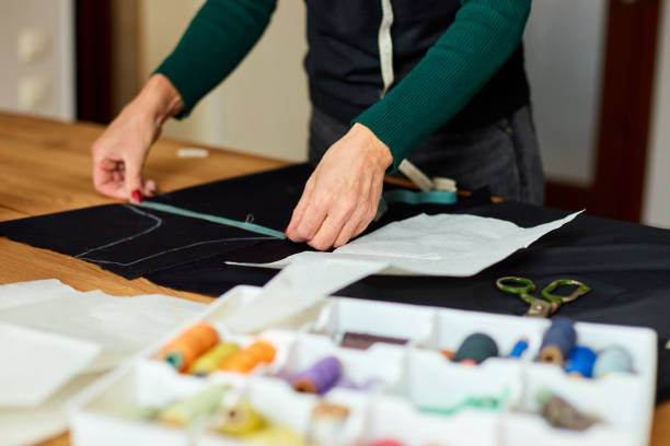 istock Step by step, woman dressmaker female measuring sewing pattern On Table 1350609495
