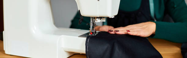 istock Step by step, 50-yers old woman sews clothes on sewing machine 1350609496