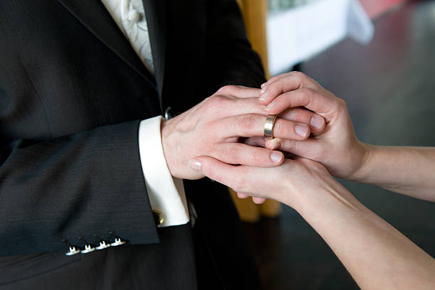 istock Bride Placing Wedding Ring on groom's Finger 135060991