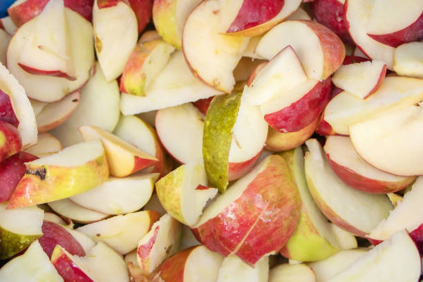 istock Sliced of apple. Chopped apples are ready for further processing 1350611200