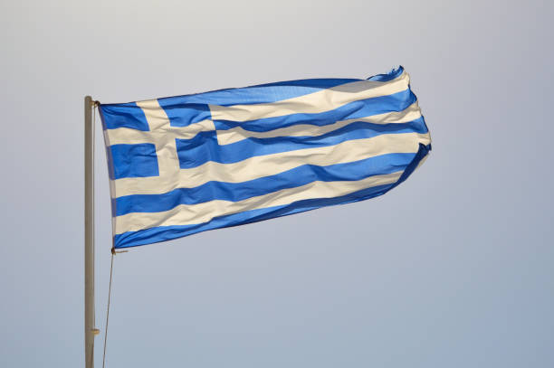 istock Sunlit Greek flag waving in the wind 1350611377