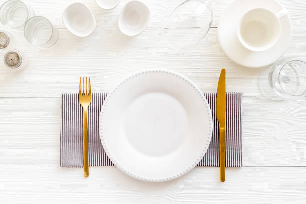 istock Tableware set with empty plate with dishware and glasses on napkin 1350612215