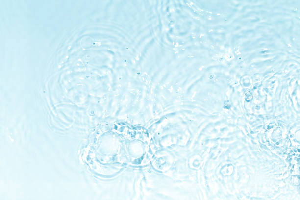 istock Blue, transparent and clear water surface with splashes and little bubbles. Water texture. Close up view. Trendy abstract nature background. 1350613628