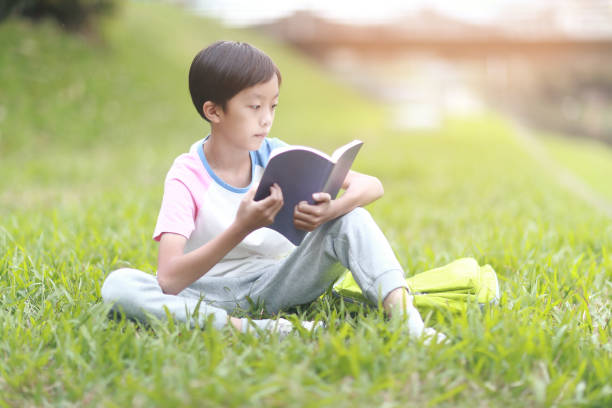 istock Little boy carrying a backpack walking back to school 1350613676