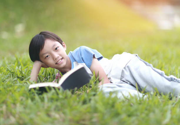istock Little boy carrying a backpack walking back to school 1350613677