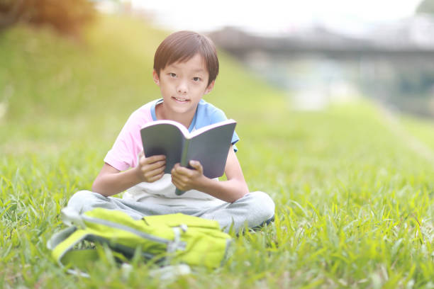 istock Little boy carrying a backpack walking back to school 1350613689