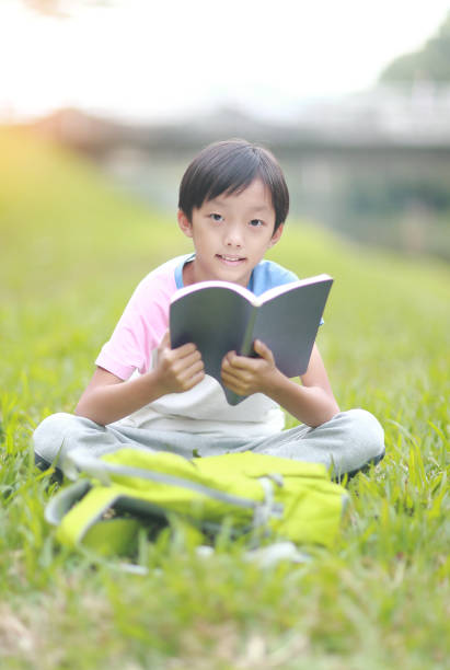 istock Little boy carrying a backpack walking back to school 1350613702