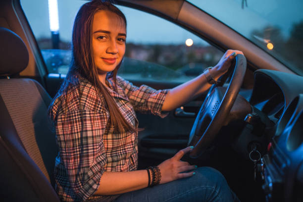 istock Female driver enjoying in the car on dusk 1350613976