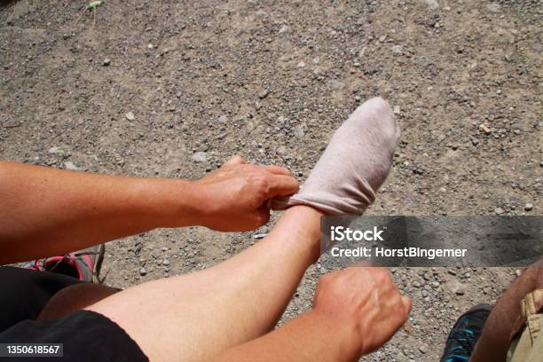 Putting A Sock On One Foot Stock Photo - Download Image Now - Body Part, Cold Temperature, Color Image