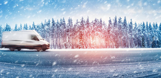 istock White van moving on a slippery asphalt road in snowfall 1350618674