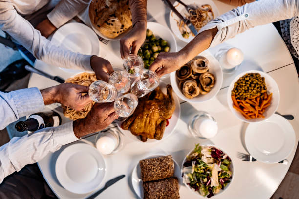 istock Cropped shot of people sharing a toast while having dinner together 1350618686