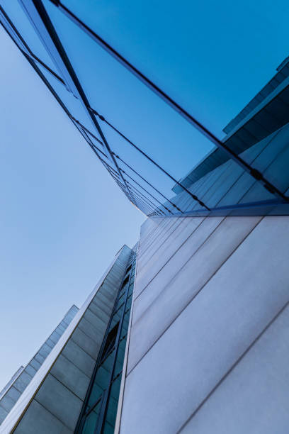 istock Low angle view on corporate building exterior in glass and concrete blocks 1350618871