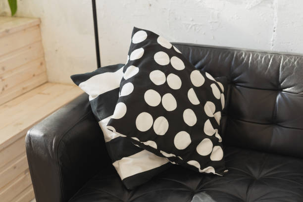 istock Black and white cushions on a sofa. Modern furniture. Loft interior 1350620274