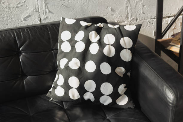 istock Black and white cushions on a sofa. Modern furniture. Loft interior 1350620368