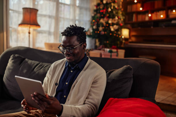 istock Man doing online Christmas shopping on his digital tablet 1350620610