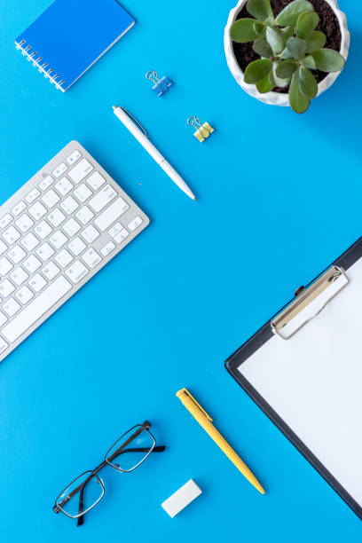 istock Top view of working place with computer keyboard and notepad 1350621196
