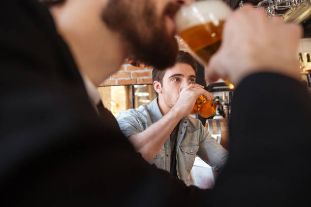 istock Cropped image of friends drinking beer 1350621361