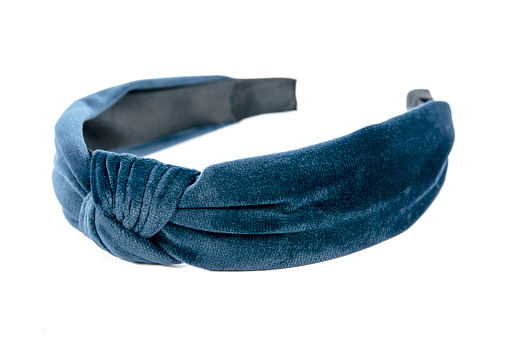 Velvet headband knot design isolated on white background. Blue velvet fabric hair band tied isolated