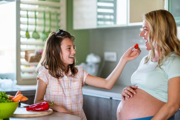 istock Daughter making lunch for her pregnant mother 1350624199