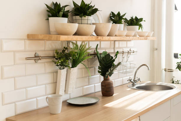 istock Stylish scandinavian open space with kitchen accessories and plants. 1350624340