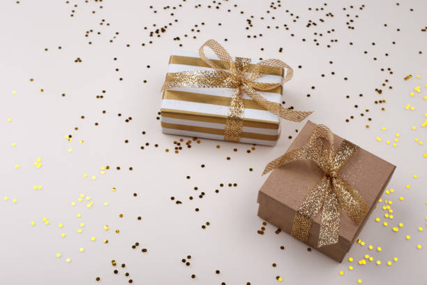 istock Golden gift boxes on beige pastel background 1350624410