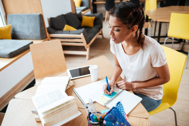 istock Pretty African woman in library 1350625664