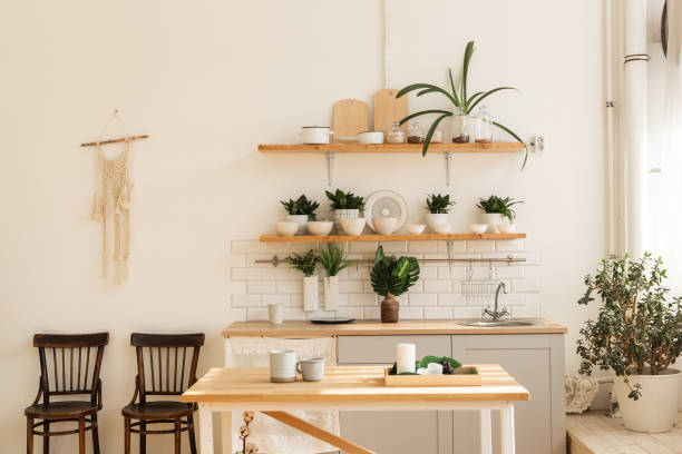 istock Stylish scandinavian open space with kitchen accessories and plants. 1350626204