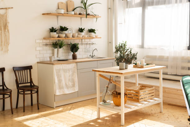 istock Stylish scandinavian open space with kitchen accessories and plants. 1350626277