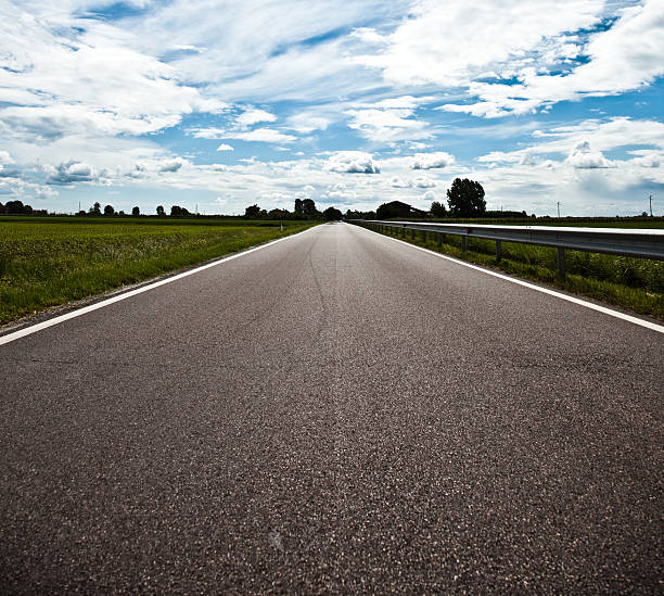 istock A empty country road with a cloudy sky in Italy 135062958
