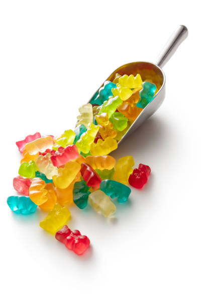 конфеты: жевательные мишки в совках, изолированные на белом фоне - chewy стоковые фото и изображения